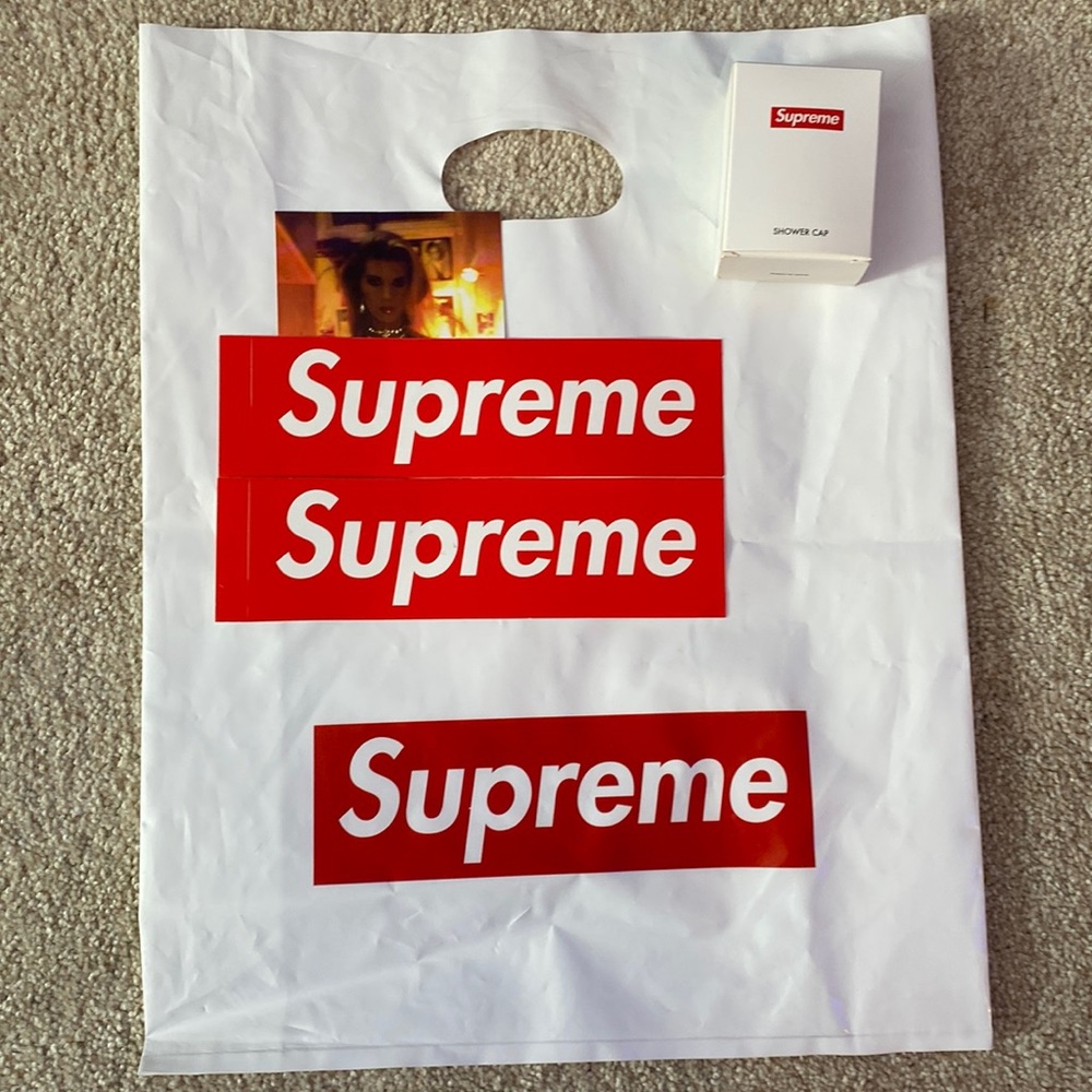 Three Supreme stickers, supreme bag and supreme shower cap.